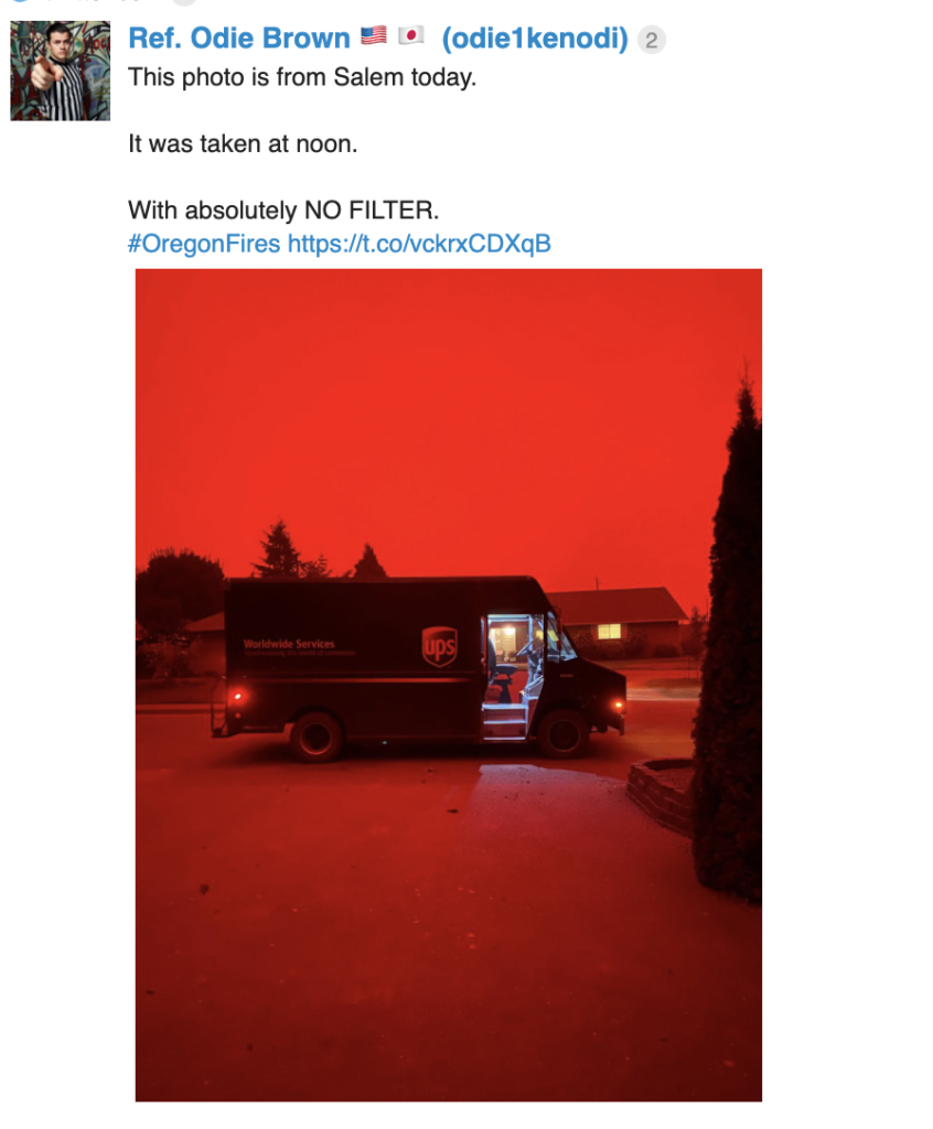 Shows a mail truck with a completely red sky 